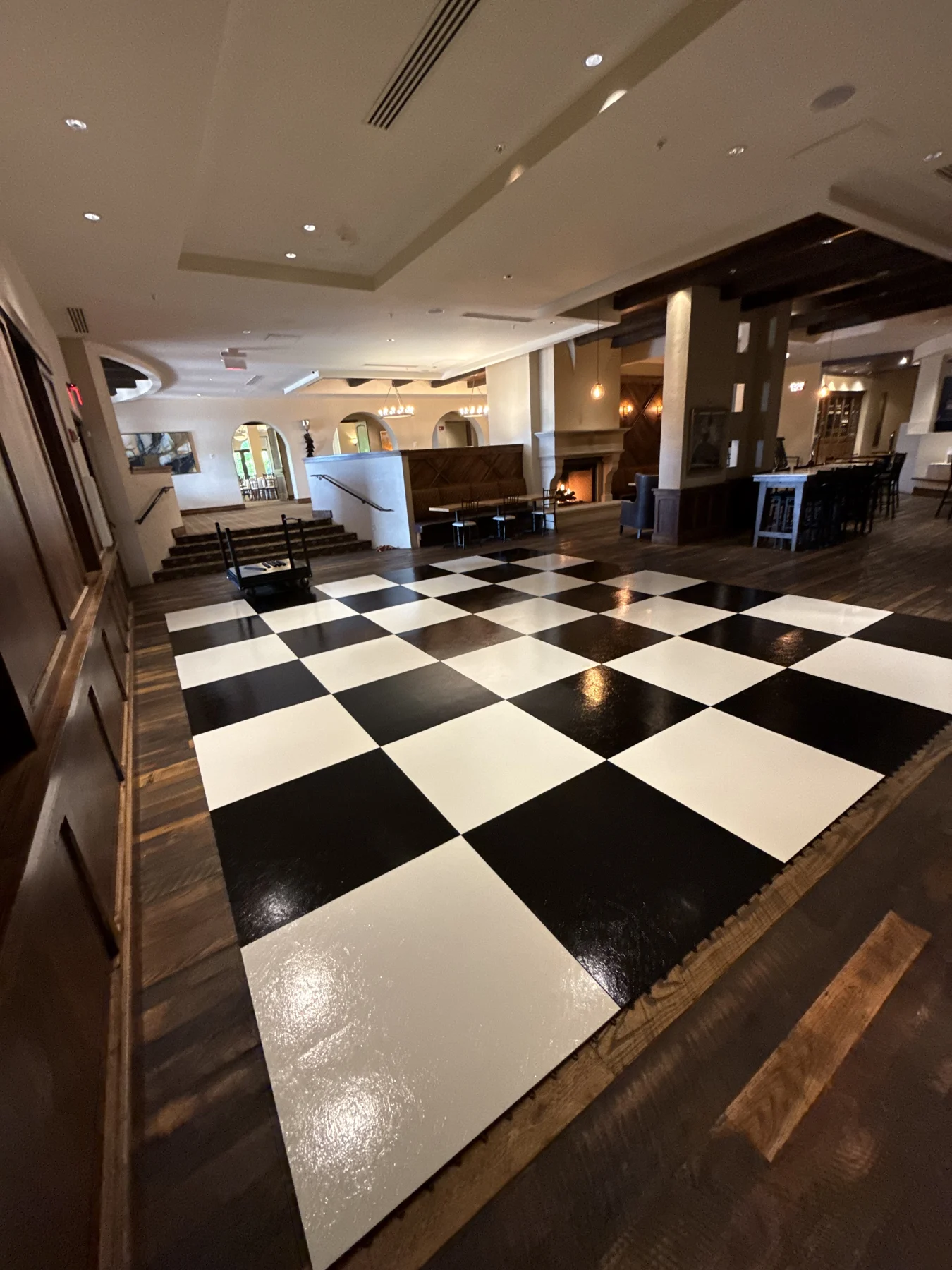 Real black-and-white floor setup seen at an angle in a wood-paneled room