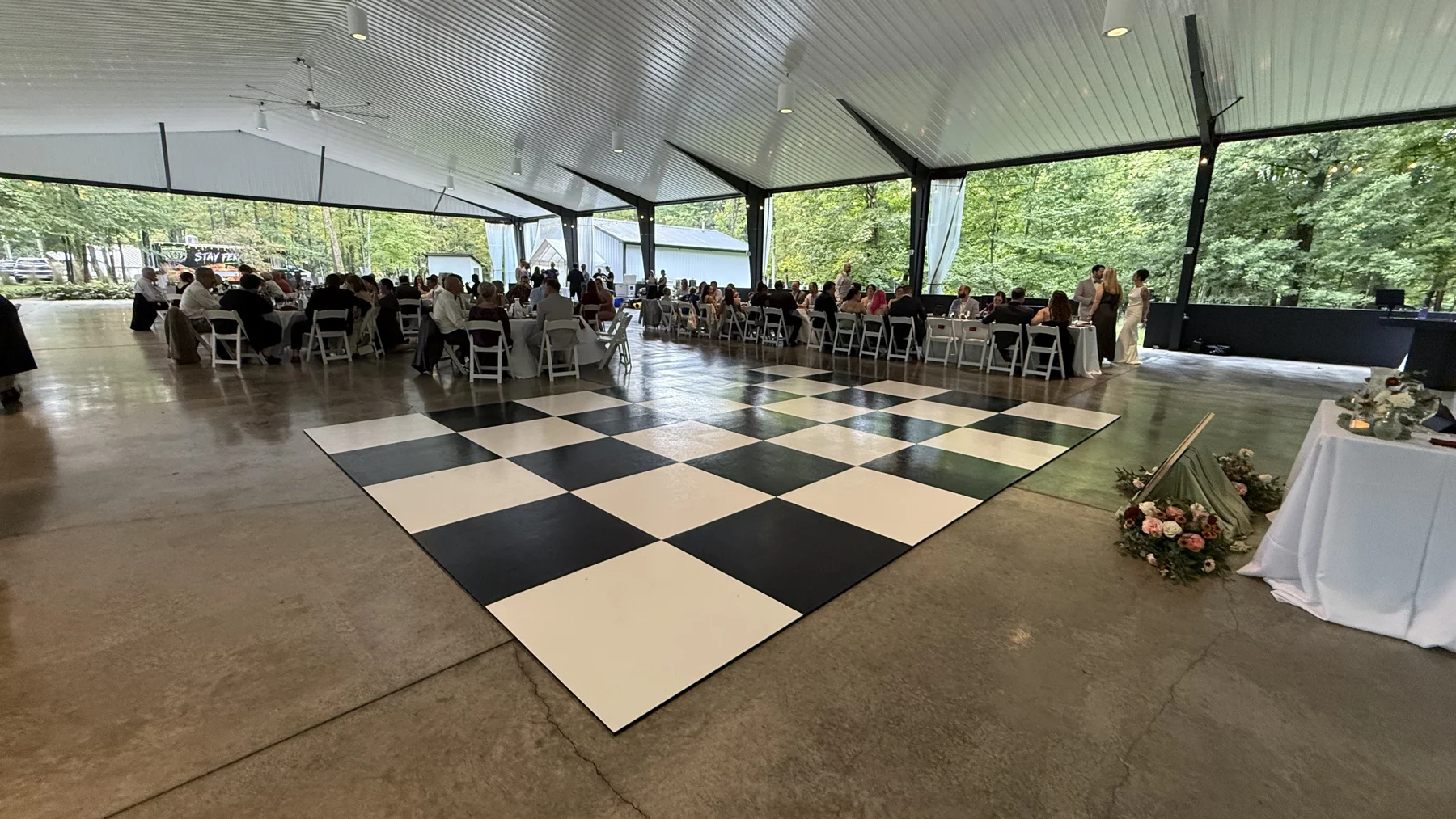 Another real view of the checkerboard floor and reception seating in a pavilion